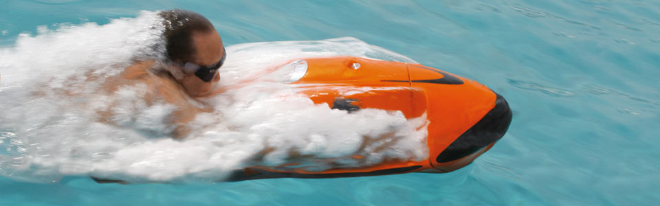 Man riding the seabob at high speed just under the surface of the water